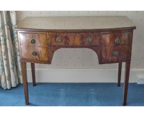 A 19th century mahogany bow fronted dressing table with five drawers on square tapering legs, 81.5cm high x 107cm wide x 57cm