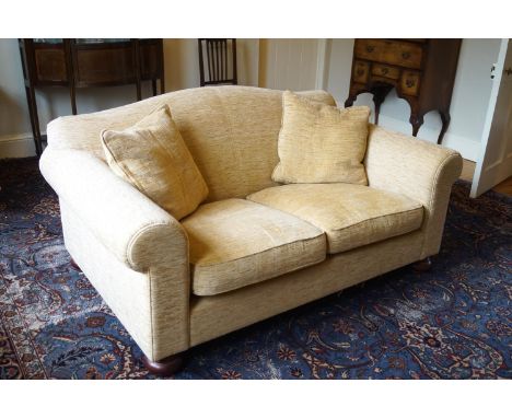 A two seat sofa upholstered in yellow on oak bun feet, 156cm wide