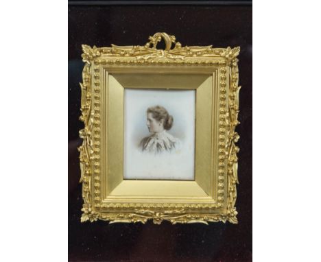 A late 19th century portrait miniature of a Lady in a gilt composite frame with bead edging, floral and foliate work, in a ve