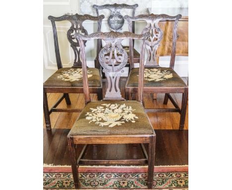 A composite set of twelve mahogany dining chairs with pierced inter-linked splats with drop in tapestry seats, on reeded legs