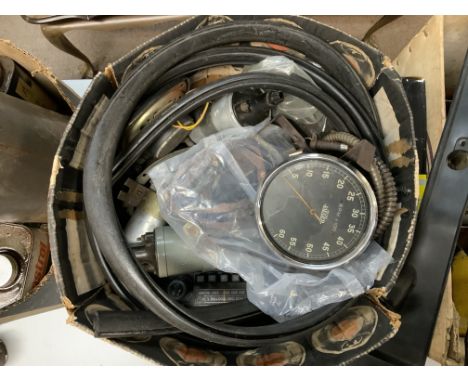 A vintage tin trunk and boxes containing a quantity of Vintage and classic car parts.
