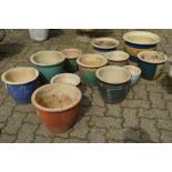 A quantity of glazed plant pots.
