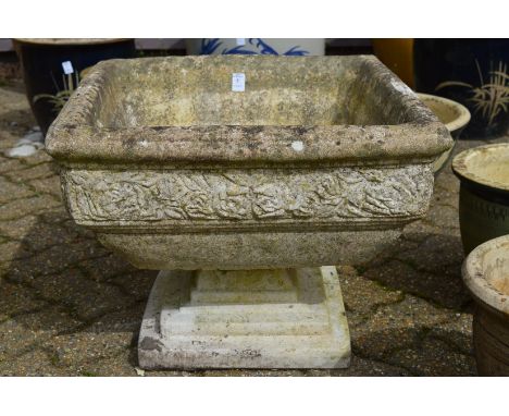 A reconstituted stone square shaped pedestal planter.
