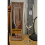 A Champagne glass to hold an entire bottle of Champagne complete with original box.