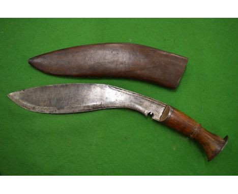 A Gurkha kukri with leather scabbard.