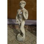 A reconstituted stone garden ornament as a standing male figure.