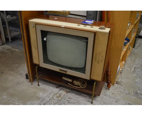 An early Philips television receiver, model number 23TG107U, complete with original manual and cable remote control.