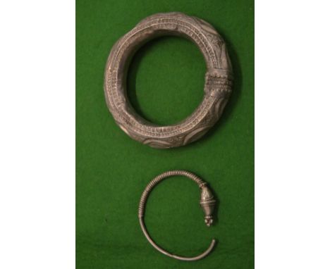 An Eastern white metal bangle and another.