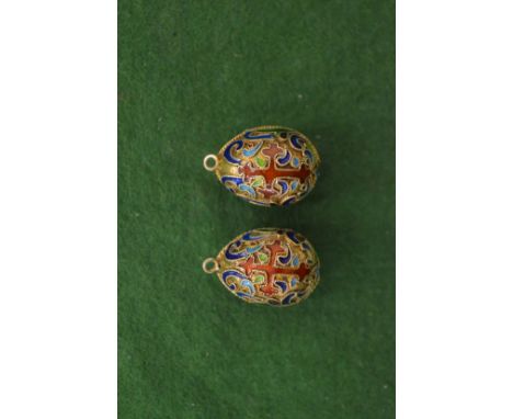 A pair of enamel decorated egg shaped pendants.
