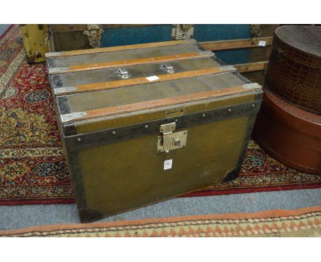 A good small metal and wooden bound travelling trunk.
