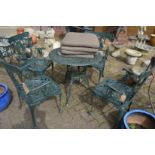 A green painted aluminium patio set comprising circular table and four armchairs.