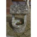 A garden planter modelled as a wishing well.
