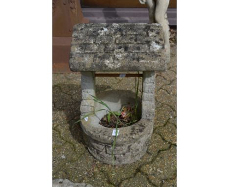 A garden planter modelled as a wishing well.