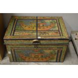Decoratively painted tin trunk.