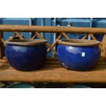 A large pair of turquoise glazed planters.