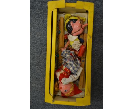 A Pelham puppet, Pinocchio, and another puppet.