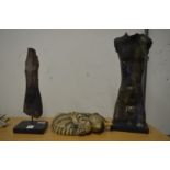 Two unusual pottery torso's together with a model of a sleeping cat.
