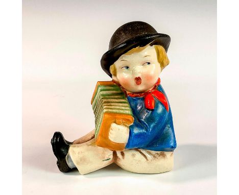 Hand-painted ceramic figurine modeled as a little boy in a blue shirt playing an accordion. Erphila tag to base. U.S. Zone Ge