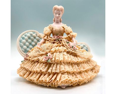 Depicts a woman in a cream-colored lace dress sitting on a sofa. Jamar Mallory Studio backstamp. Dimensions: 9.5"L x 5.5"W x 