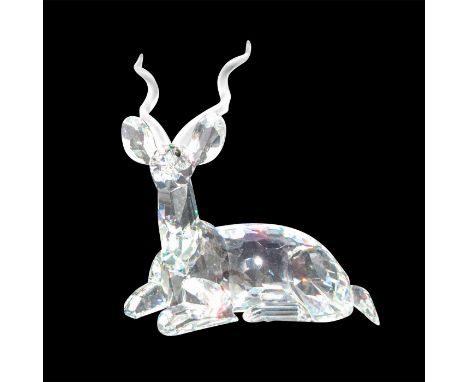 Brilliant cut crystal figure of a kudu, a type of antelope, lying down resting, with satin horns. The second of the Inspirati