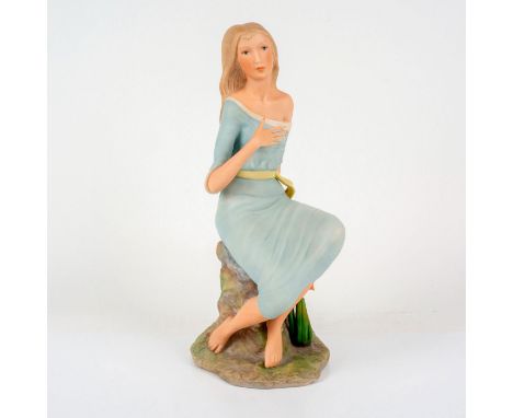 Featuring blonde woman in light blue fabric seated on rock formation. Number and edition size located on bottom of piece. Isp