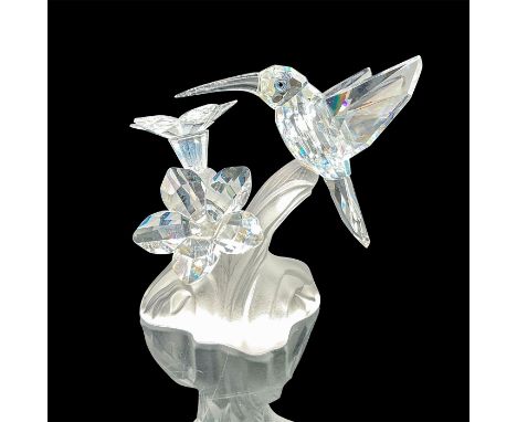 This retired hummingbird was part of the Feathered Beauties theme. The hummingbird and flowers are made from clear crystal, e
