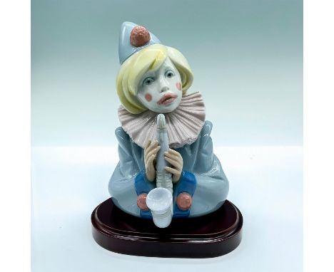 Glossy porcelain figure of young clown with saxophone. Lladro backstamp. This item has a base included. Base dimensions: 5.74