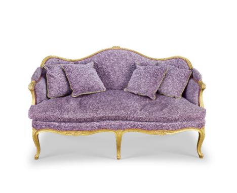 A George III giltwood sofa1775-1780, in the French tasteWith shaped and channelled frames, the toprail with a central floral 