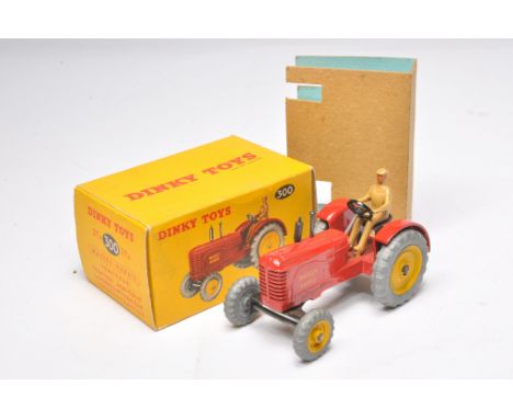 Dinky No. 300 Massey Harris Tractor. Metal wheels. Displays generally excellent. Little sign of wear. In excellent original b