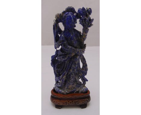 A Chinese lapis lazuli carved figurine of a female figure on triangular hard wood stand, 16cm (h)