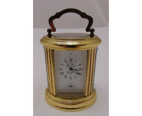 A L'pee France miniature brass shaped oval carriage clock white enamel dial, Roman numerals and subsidiary seconds dial, 8cm 