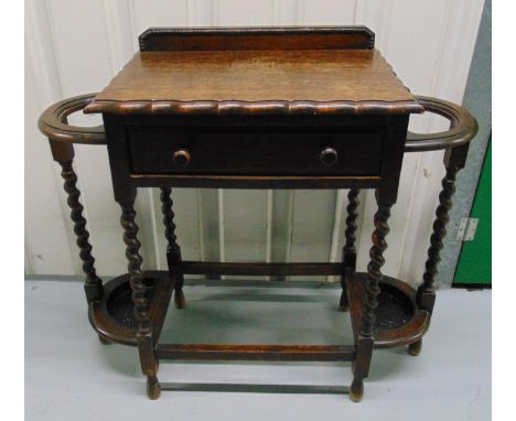 A shaped rectangular oak umbrella and stick stand with single drawer and six barley twist columnular supports, 81 x 89 x 41cm