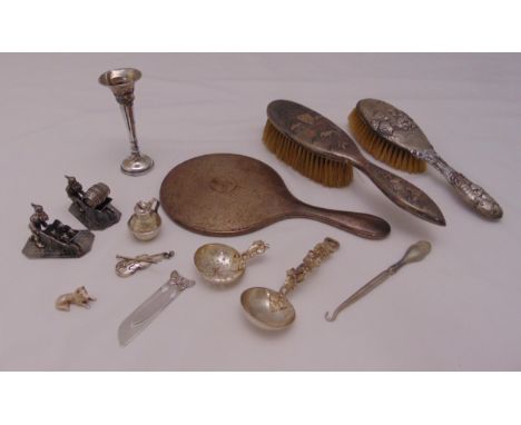 A quantity of hallmarked silver and white metal to include dressing tables brushes, a mirror, a button hook and figurines, A/