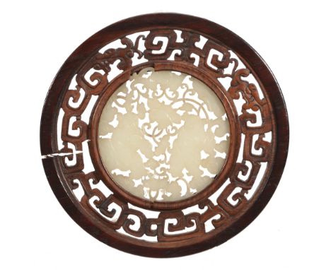 A Chinese white jade roundel, late Qing Dynasty A Chinese white jade roundel, late Qing Dynasty, carved and pierced on each s