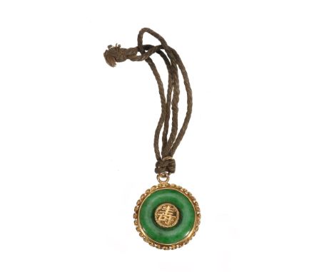 A small Chinese green jade and gold circular pendant, circa 1900-1920 A small Chinese green jade and gold circular pendant, c