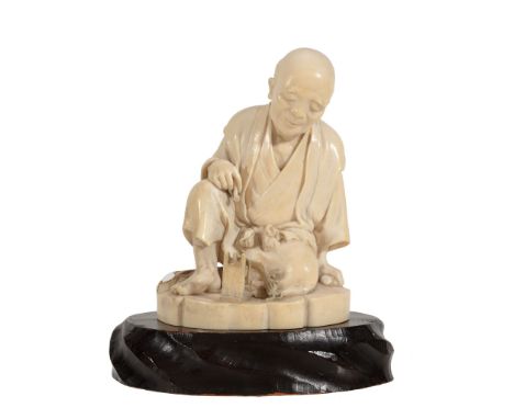 A Japanese Tokyo School Ivory Okimono depicting a waraji maker seated and... A Japanese Tokyo School Ivory Okimono depicting 