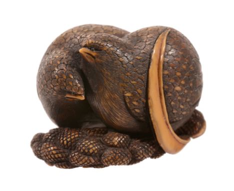 An Ivory Netsuke of Two Quail, the two birds stand side-by-side on heads of... An Ivory Netsuke of Two Quail, the two birds s