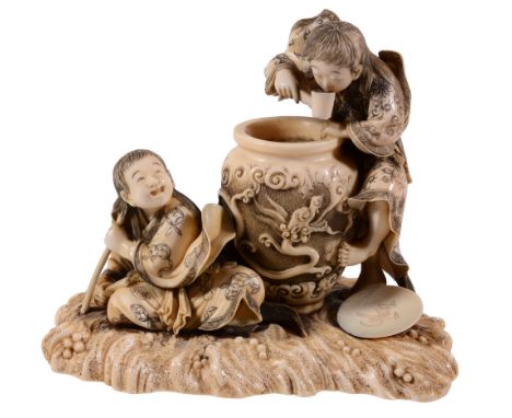 A Good Ivory Okimono of Two Drunken Shojo, one stands beside a large sake jar A Good Ivory Okimono of Two Drunken Shojo, one 
