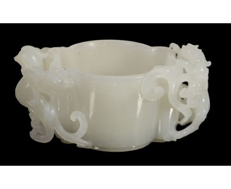 A Chinese white jade cup, 20th century, of lobed circular section A Chinese white jade cup, 20th century, of lobed circular s