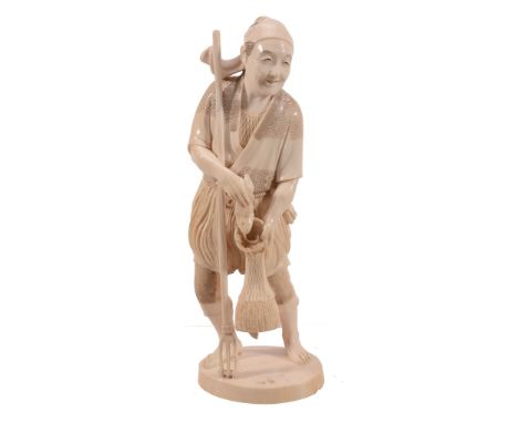 An Ivory Okimono of a Spear Fisherman, he stands on an oval base dressed in... An Ivory Okimono of a Spear Fisherman, he stan