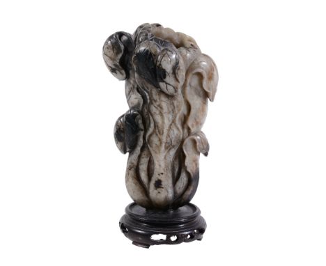 A carved jade flower vase, 19th/early 20th century A carved jade flower vase, 19th/early 20th century, of slender with black 