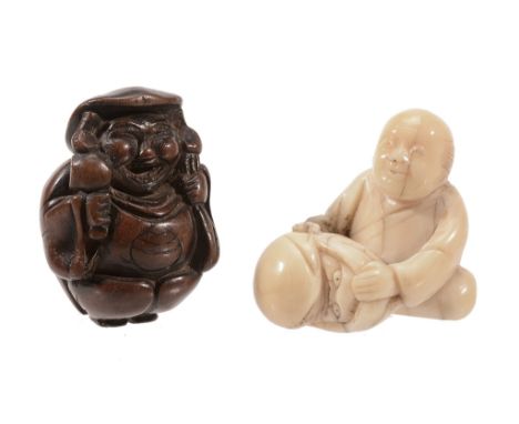 A Wood Netsuke of Daikoku, the portly figure stands with his sack over one... A Wood Netsuke of Daikoku, the portly figure st