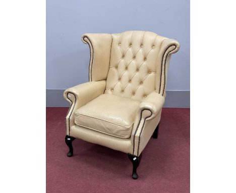 Cream Button Back Leather Wing Armchair, with studded decoration, on cabriole legs, 90cm wide