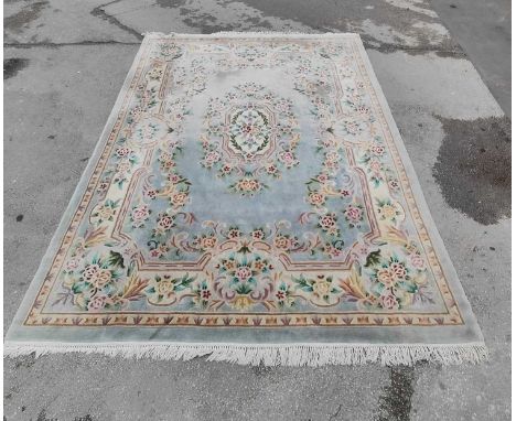 Chinese Wool Tassled Carpet, allover floral decoration on a silver blue ground (fading?), approximately 358 x 275cm.