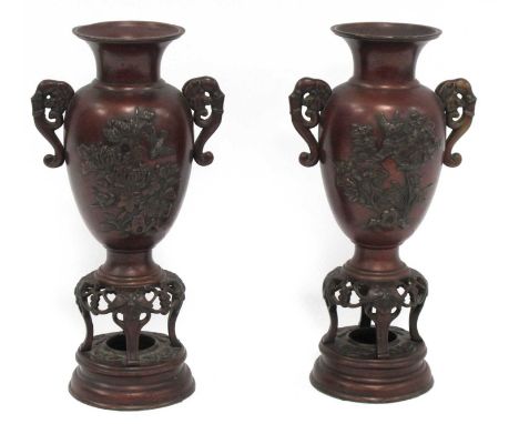 Oriental Pair of Japanese Bronze Vases, Meiji Period, each with elephant handles to ovoid body on four-legged supports and a 