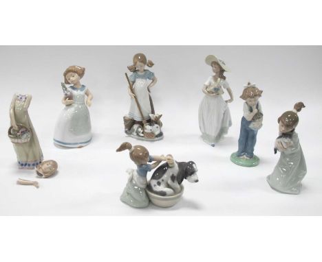 Four Lladro Figurines of Girls Holding a Cat, holding a basket, washing a dog in a tub, a girl holding a mop and cats at her 