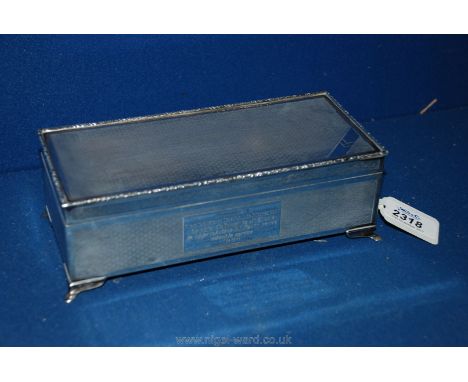 A Silver Table Cigar Box with all over engine turned decoration, four pad feet and a presentation plaque marked Birmingham af