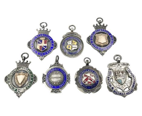 Seven early 20th century and later silver and enamel cartouche fobs, all relating to football, to include a circular example,