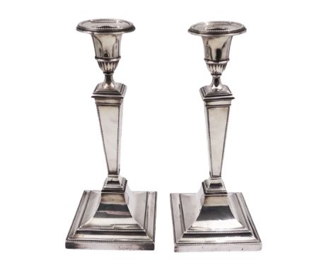 Pair of 1920s silver mounted candle sticks, each with part fluted candle holders and removable sconces, upon a tapering stem 