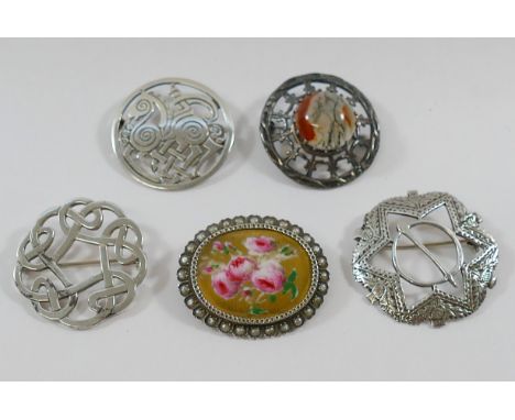 A Victorian oval brooch with central hand painted porcelain panel decorated with roses, with half pearl surround, a Scottish 